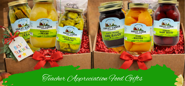 Teacher appreciation gift boxes featuring assorted jars of pickles, sauces, and preserved vegetables arranged in decorative packaging with red bows