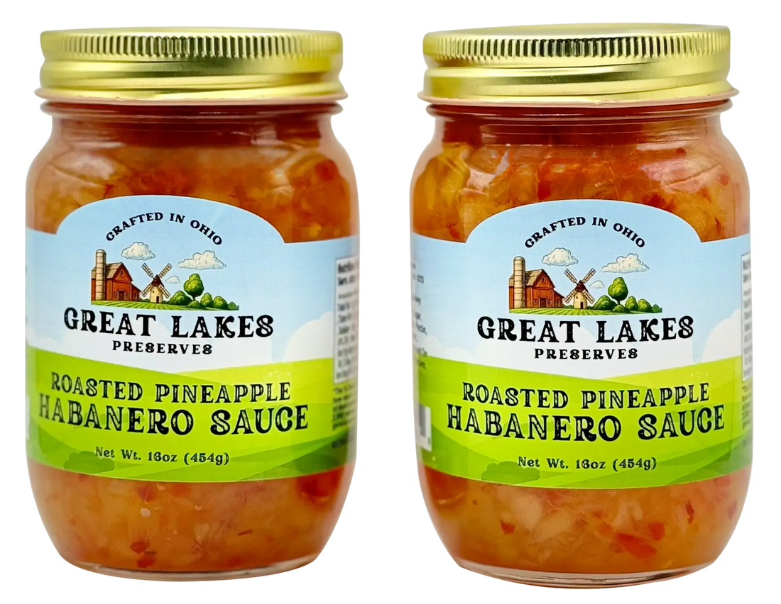 Two Great Lakes Preserves Roasted Pineapple Habanero Sauce jars with gold lids, front labels facing.