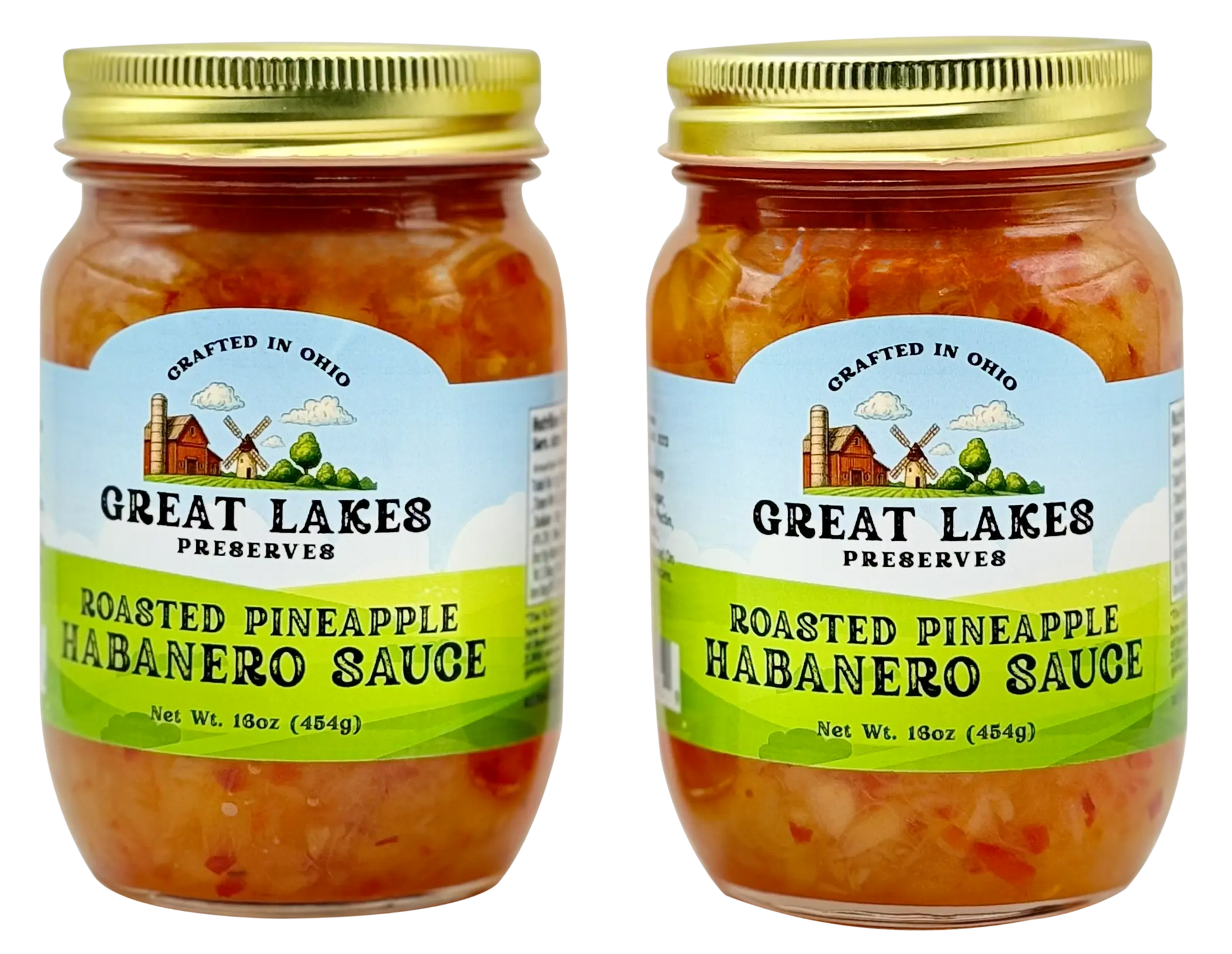 Two Great Lakes Preserves Roasted Pineapple Habanero Sauce jars with gold lids, front labels facing.